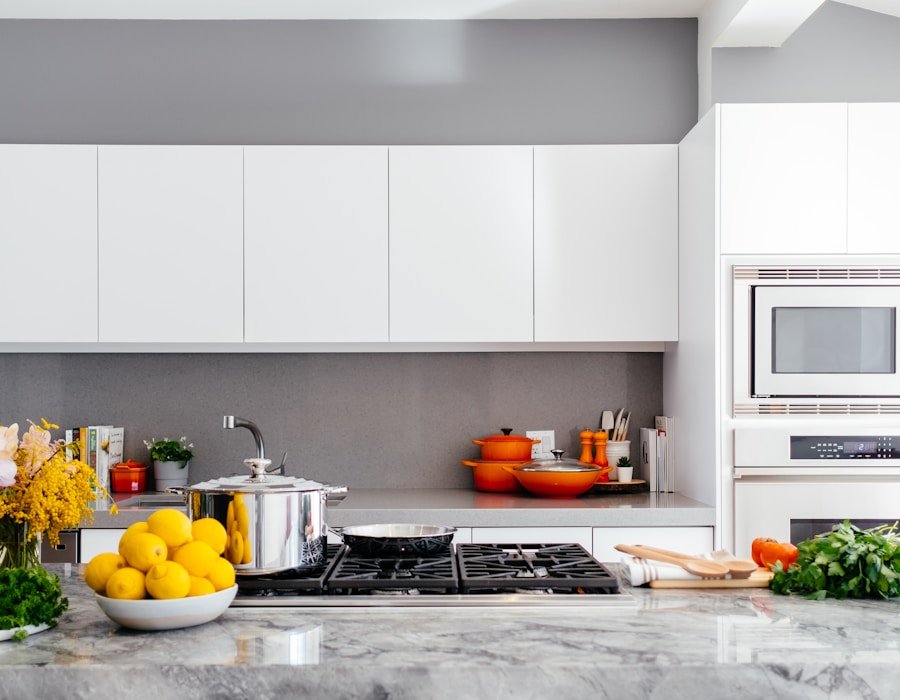 Modern Montreal kitchen with a veined marble-granite countertop, range, and warm wood accents — the kind of finished work Montreal Granite delivers across the island